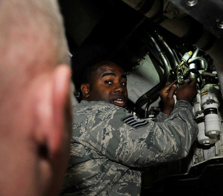 U.S. Air Force Tech Sgt. Broderick Jones, 509th Aircraft Maintenance Squadron aircraft electrical and environmental systems craftsman, explains proper wire maintenance to Senior Airman Senior Airman Matthew Quick, 509th AMXS electrical environmental journeyman, at Whiteman Air Force Base, Mo., June 10, 2014. If wire maintenance is performed poorly, it could result in damaging the aircraft. (U.S. Air Force photo by Airman 1st Class Keenan Berry/Release)