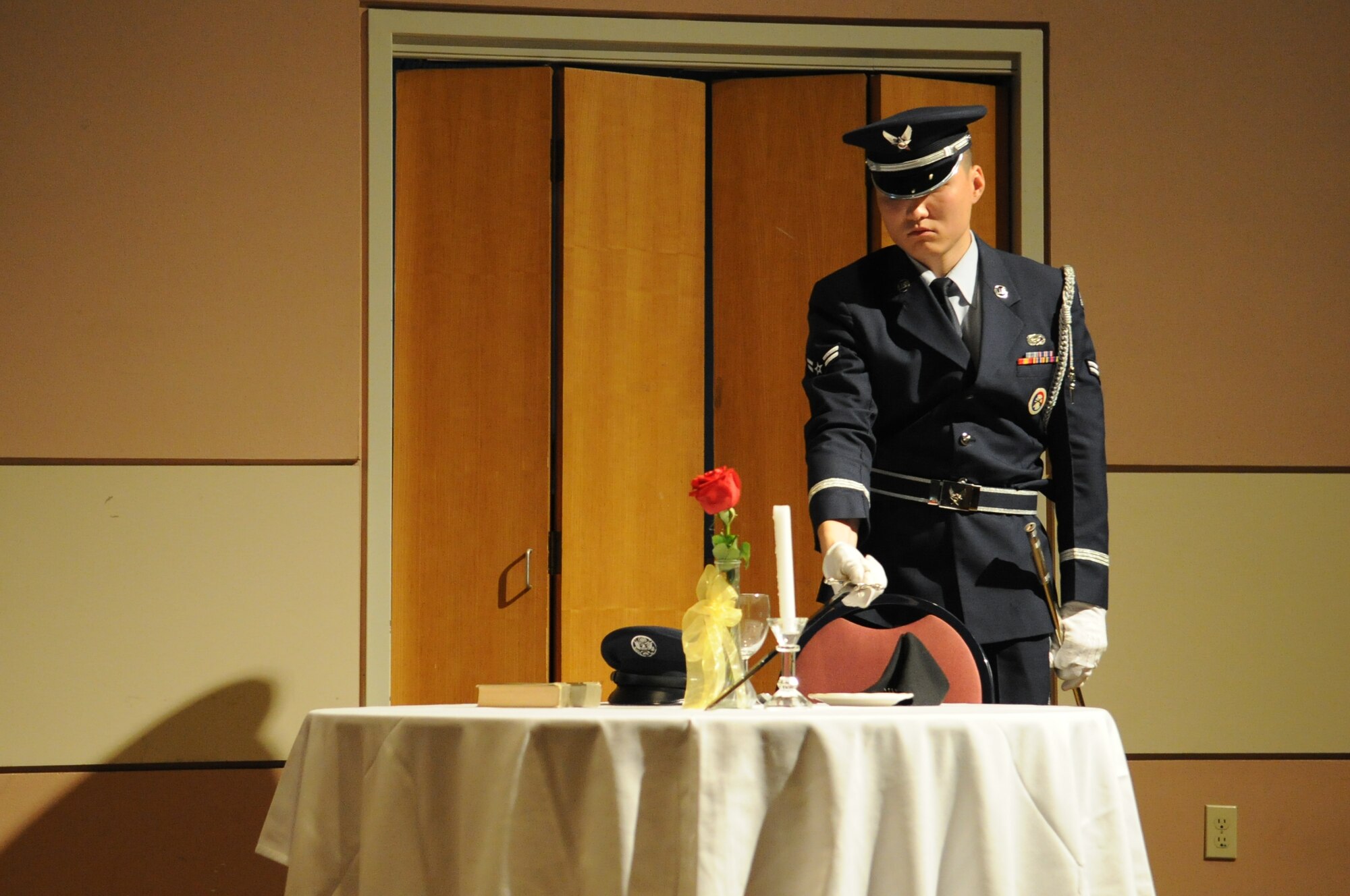 GOODFELLOW AIR FORCE BASE, Texas -- Airman 1st Class Aziz N. Sarbashev, 17th Force Support Squadron personnel technician, lays down his weapon in memory of fallen comrades who have lost their lives while bearing arms in defense of this nation during the remembrance ceremony for the Senior NCO Induction Ceremony at the Event Center here June 13. The SNCO Induction Ceremony welcomes and inducts the newest senior enlisted leaders. (U.S. Air Force photo/ Staff Sgt. Laura R. McFarlane)