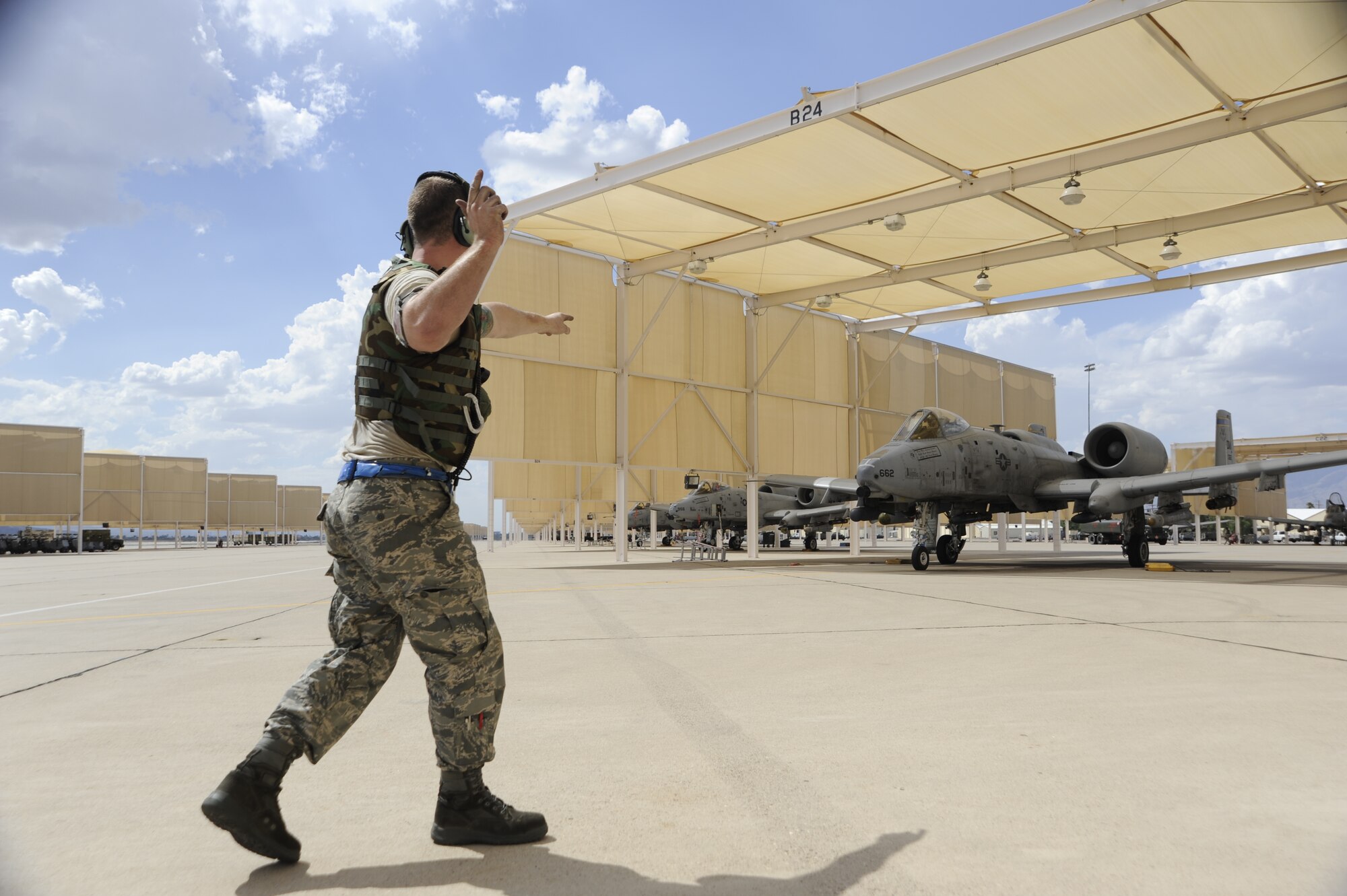 U.S. Air Force Senior Airman Iain McElrath, 354th Aircraft Maintenance Squadron crew chief, marshals out an A-10 Thunderbolt II during an Operational Readiness Exercise held at Davis-Monthan Air Force Base, June 17, 2014. These exercises are held to ensure D-M's Airmen maintain the highest levels of proficiency and readiness for worldwide military and humanitarian operations.(U.S. Air Force photo by Airman 1st Class Betty R. Chevalier/Released)