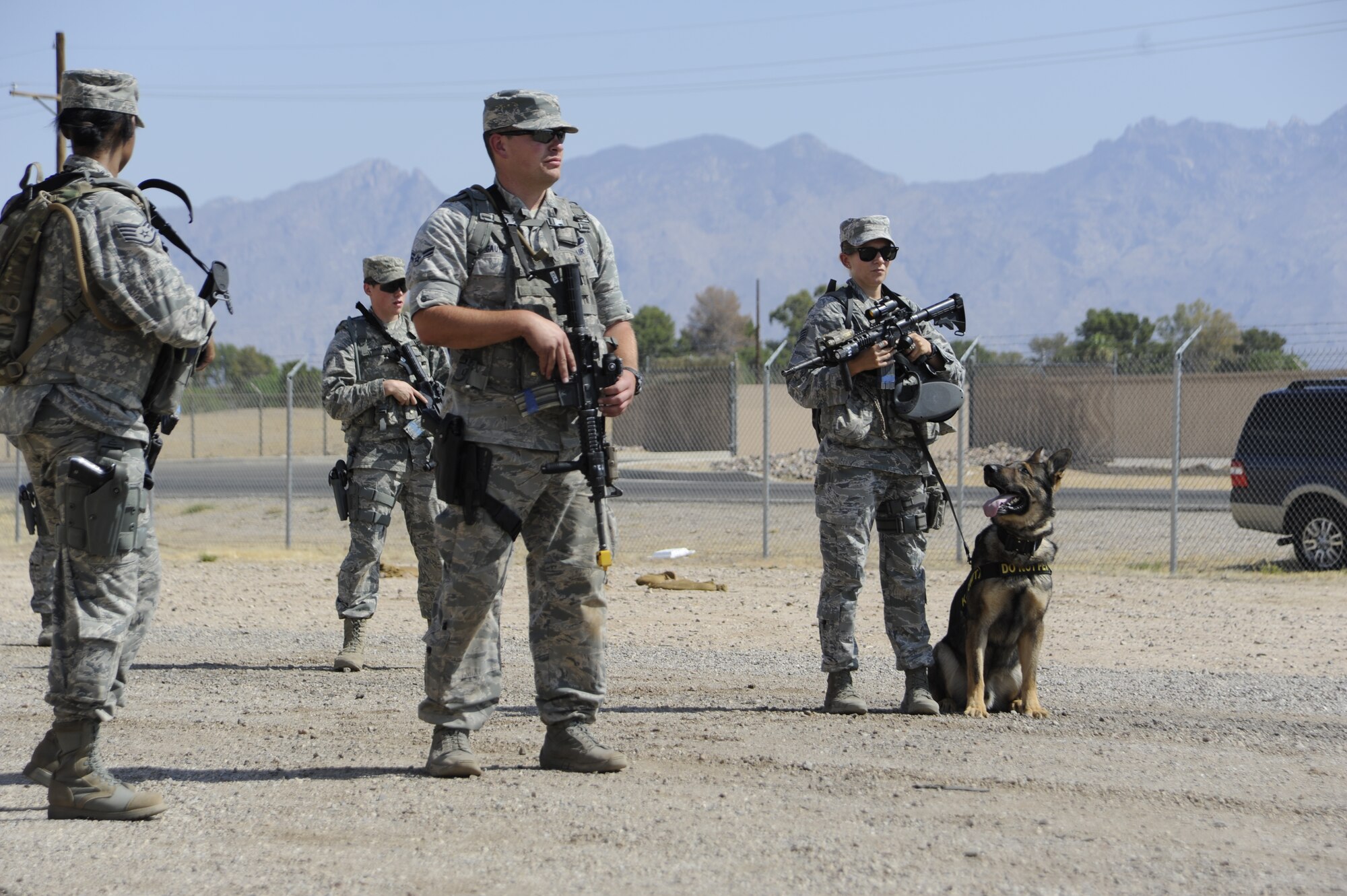 Members of the 355th Security Forces Squadron patrol “Base-X” during an Operational Readiness Exercise at Davis-Monthan Air Force Base, Ariz., June 17, 2014. Security Forces personnel use military working dogs to assist guarding base entries and patrolling the perimeter. (U.S. Air Force photo by Airman 1st Class Betty R. Chevalier/Released)