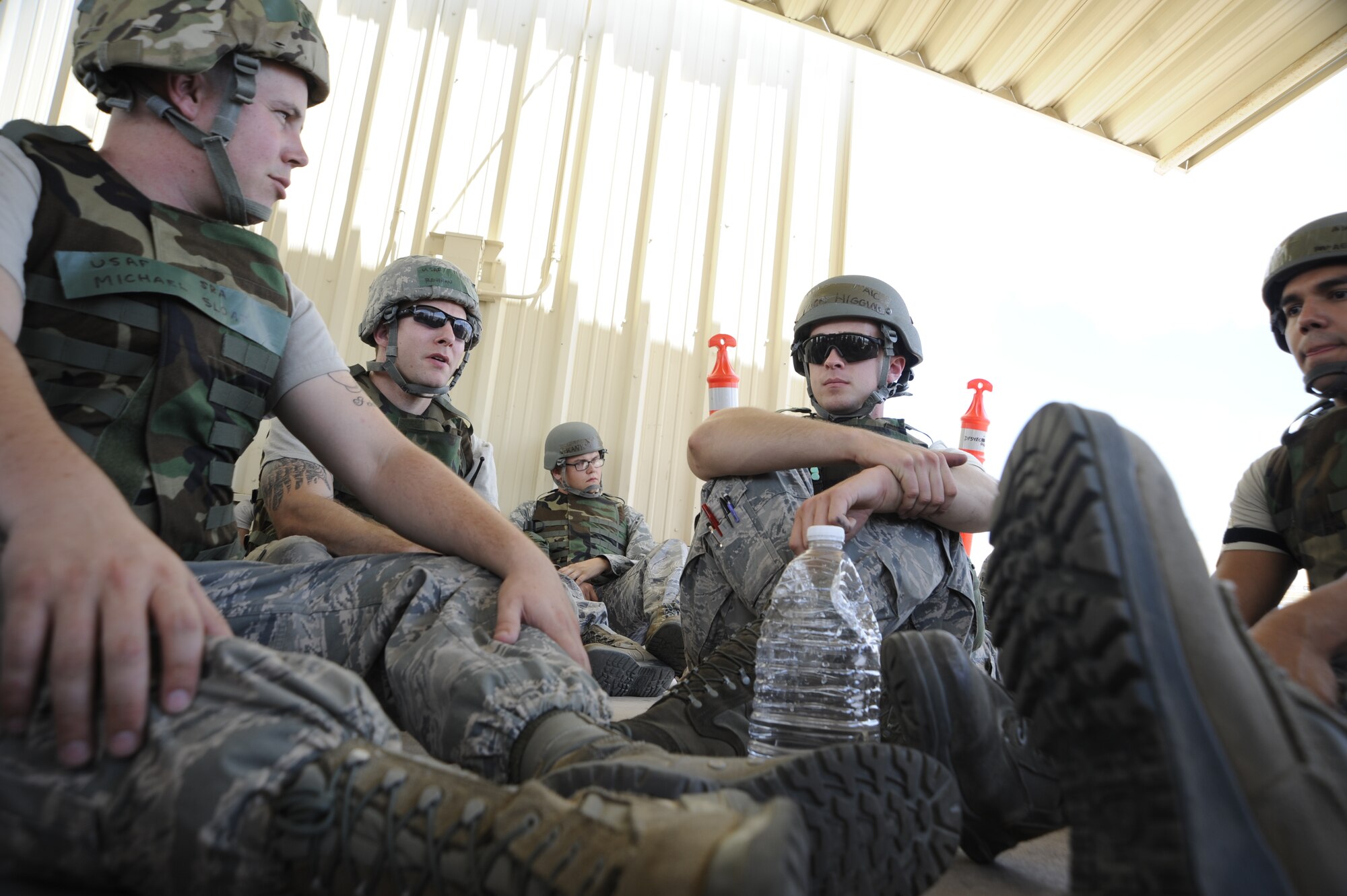 U.S. Air Force Airmen from the 354th Aircraft Maintenance Unit take shelter in a simulated bunker after an alarm sounded during an Operational Readiness Exercise held at Davis-Monthan Air Force Base, Ariz., June 17, 2014. This exercise was designed to test and prepare Airmen for deployed operations. (U.S. Air Force photo by Airman 1st Class Betty R. Chevalier/Released)