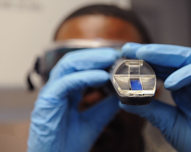 Staff Sgt. Jason Flowers, 2nd Logistics Readiness Squadron fuels laboratory technician, looks through a refractometer to measure the amount of icing inhibitor that is inside the fuel sample on Barksdale Air Force Base, La., June 18, 2014. Water inside the fuel will freeze at high altitudes inside the B-52H Stratofortress fuel systems, to avoid this, an icing inhibitor is placed inside the fuel. Flowers was ensuring the correct amount of the inhibitor was inside the fuel he was testing. (U.S. Air Force photo/Senior Airman Benjamin Gonsier)
