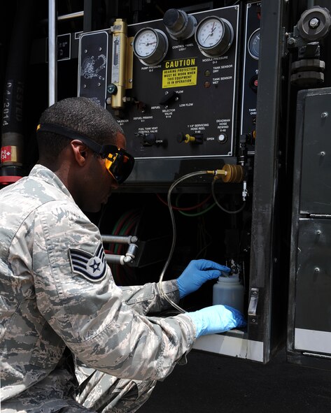 Staff Sgt. Jason Flowers, 2nd Logistics Readiness Squadron fuels laboratory technician, passes fuel through an inline sampler to an aeronautical engineering laboratory pad on Barksdale Air Force Base, La., June 18, 2014. The AEL pad tests for the amount of water inside a fuel sample. (U.S. Air Force photo/Senior Airman Benjamin Gonsier)