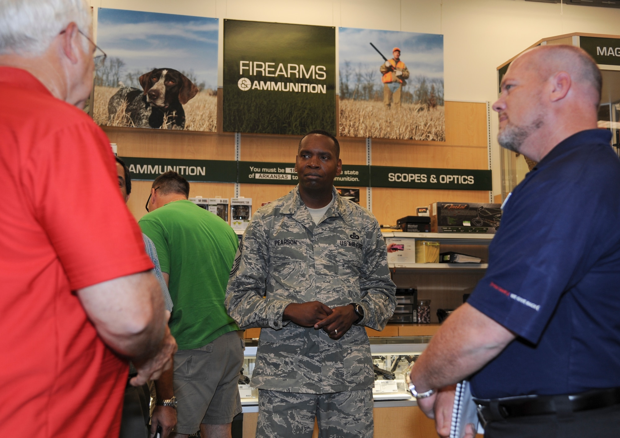 Chief Master Sgt. Anthony Pearson, Army and Air Force Exchange Service senior enlisted advisor, talks to Donald Smith, retired Air Force chief master sergeant, and Frank Sewell, Base Exchange store manager, June 18, 2014, at Little Rock Air Force Base, Ark. Pearson toured the Base Exchange along with several other AAFES establishments on base. (U.S. Air Force photo by Airman 1st Class Harry Brexel)
