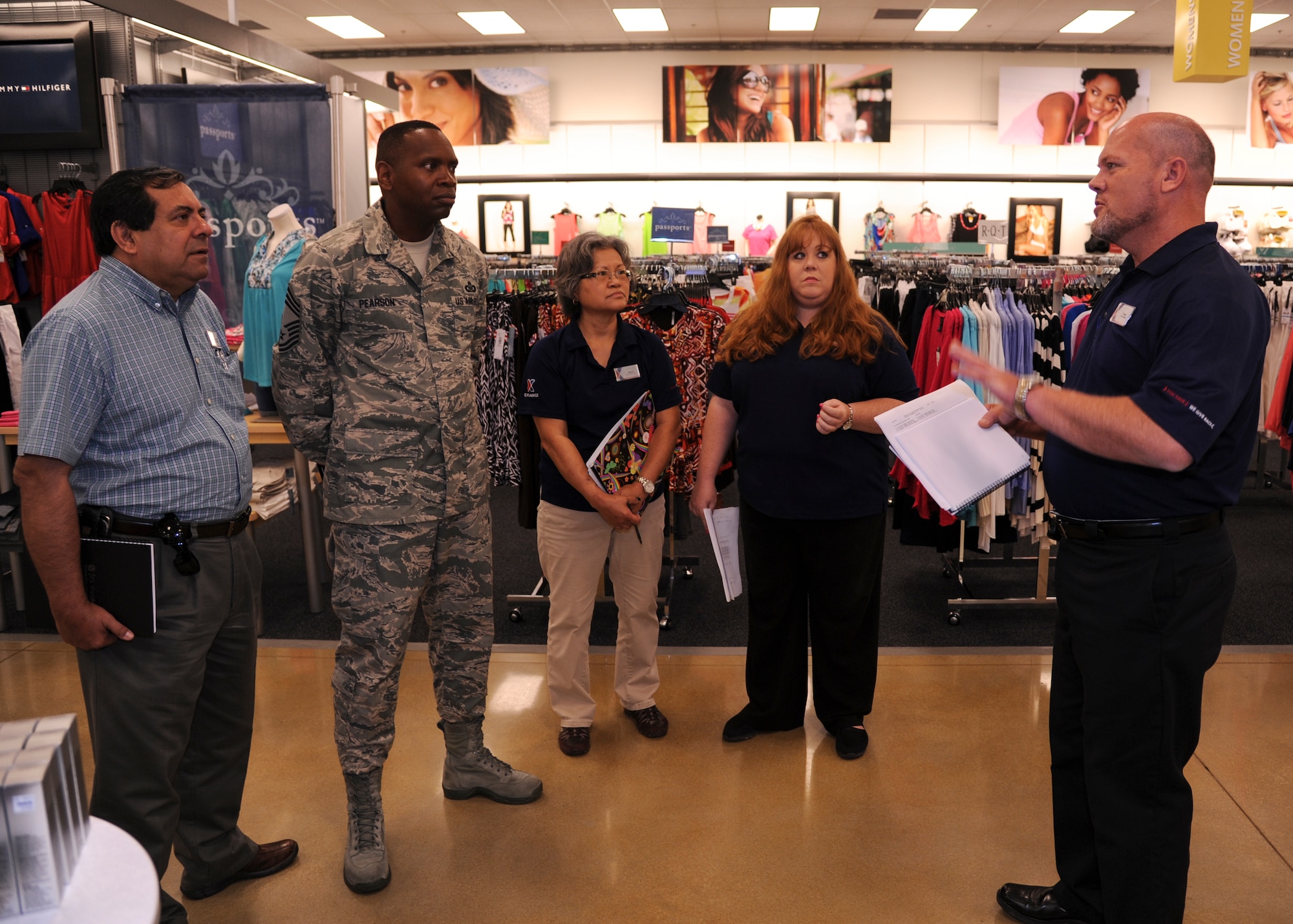 Chief Master Sgt. Anthony Pearson, Army and Air Force Exchange Service senior enlisted advisor, listens to a briefing by Frank Sewell, Base Exchange store manager, June 18, 2014, at Little Rock Air Force Base, Ark. The Exchange provides patrons with quality merchandise and services at competitively low prices, along with generating nonappropriated fund earnings as a supplemental source of funding for military morale, welfare and recreation programs. (U.S. Air Force photo by Airman 1st Class Harry Brexel)