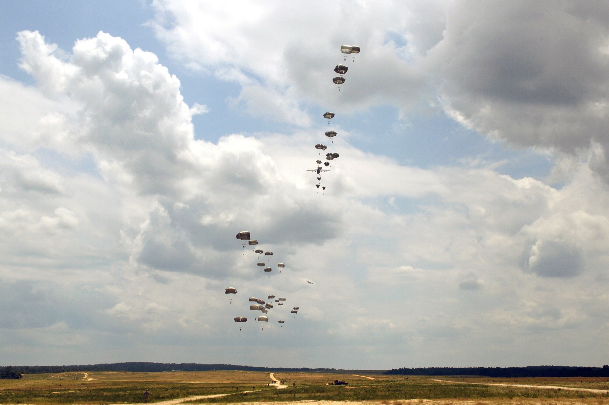 Forty Tactical Air Control Party and Battlefield Weather Airmen from the 18th Air Support Operations Group, 18th Weather Squadron and 14th Air Support Operations Squadron, jumped with over 300 paratroopers from the 27th Engineer Battalion (C) (A) and 82nd Sustainment Brigade, over Fort Bragg’s Normandy Drop Zone on June 6, 2014, commemorating the paratroopers who jumped into France on June 6, 1944 to begin the push into Europe to defeat the German Army during World War II. (U.S. Air Force photo/Marvin Krause)