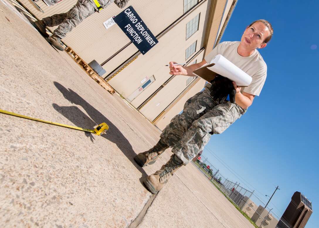 In an exchange of best practices with New York National Guard 2nd Squadron, 101st Cavalry members, 914th Airlift Wing Senior Airman Jessica Geffers demonstrates how to weigh, measure and secure deployable equipment for airlift, June 07, 2014, Niagara Falls Air Reserve Station, NY. Exercises like this highlight the importance of interoperability between branches in a joint environment. (U.S. Air Force photo by Tech. Sgt. Joseph McKee)