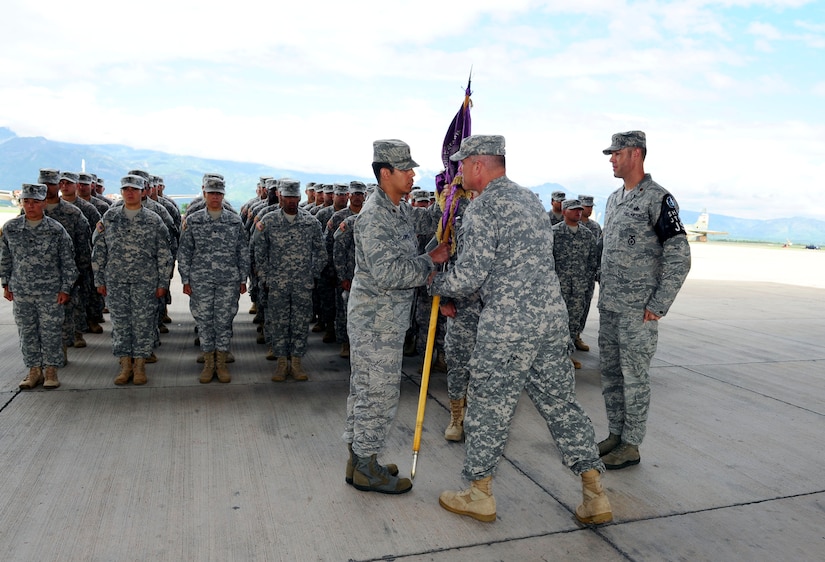 U. S. Air Force Maj. Andres Lopez assumes command of the Joint Task Force-Bravo Joint Security Forces at Soto Cano Air Base, Honduras by accepting the guidon from U. S. Army Col. Thomas Boccardi, the Joint Task Force-Bravo commander, June 18, 2014. Lopez assumed command from outgoing commander U. S. Air Force Maj. Robert Shaw, Jr. The mission of Joint Security Forces is to conduct installation security and provide security support for personnel recovery, search and rescue, counter-terrorism, counter-narcotics terrorism, disaster response, noncombatant evacuation order, and humanitarian/civic assistance in support of Joint Task Force-Bravo theater-wide operations.  (Photo by Martin Chahin)