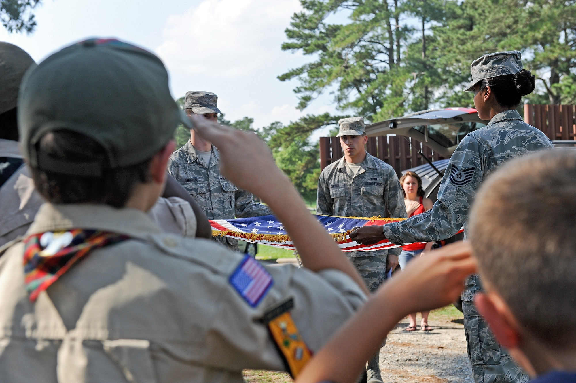 Local Boy Scouts salute during a flag retirement ceremony June 14, 2014, at Seymour Johnson Air Force Base, North Carolina. Worn, torn, soiled and faded flags were collected and retired by incineration. (U.S. Air Force photo/Airman 1st Class Aaron J. Jenne)