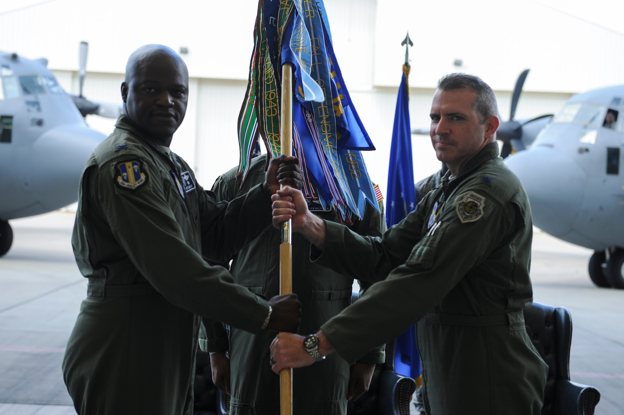 Lt. Col. Charles Bolton (right) assumes command of the 314th Operations Group June 17, 2014, at Little Rock Air Force Base, Ark.  Bolton assumed command from Col. Lee Flint in a ceremony officiated by Col. Keith Green (left), 314th Airlift Wing vice commander. (U.S. Air Force photo by Airman 1st Class Cliffton Dolezal)