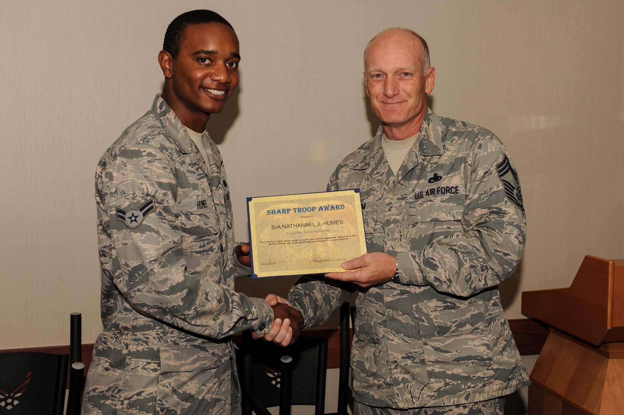 Airman 1st Class Nathaneal Humes, a 314th Aircraft Maintenance Squadron aircraft maintenance apprentice, is congratulated by Chief Master Sgt. Timothy Grisham, a 314th Aircraft Maintenance Squadron superintendent, June 16, 2014, at Little Rock Air Force Base, Ark. Humes was recognized by the Chiefs Group for acing three quality assessment evaluations, aiding the units 100 percent pass rate over the last 14 months and was also awarded the Aircraft Maintenance Unit Airman of the Month, February  2014. (U.S. Air Force photo by Airman 1st Class Cliffton Dolezal)