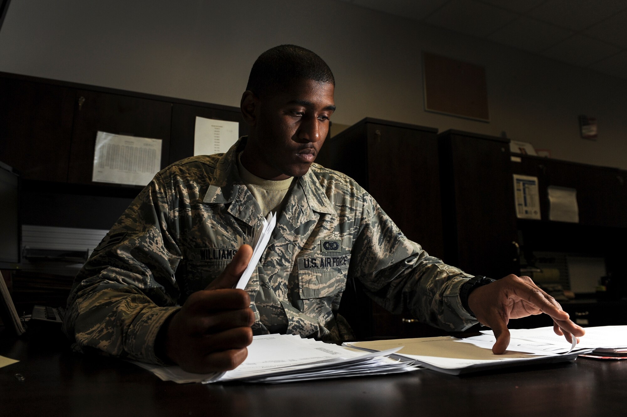 Airman 1st Class Vincent Williams, a 62nd Airlift Squadron aviation resource manager apprentice, sorts through training accomplishment reports June 17, 2014, at Little Rock Air Force Base, Ark. TAR’s are used by aircrew to log flight events such as takeoffs, landings and many other procedures. (U.S. Air Force photo by Airman 1st Class Cliffton Dolezal)