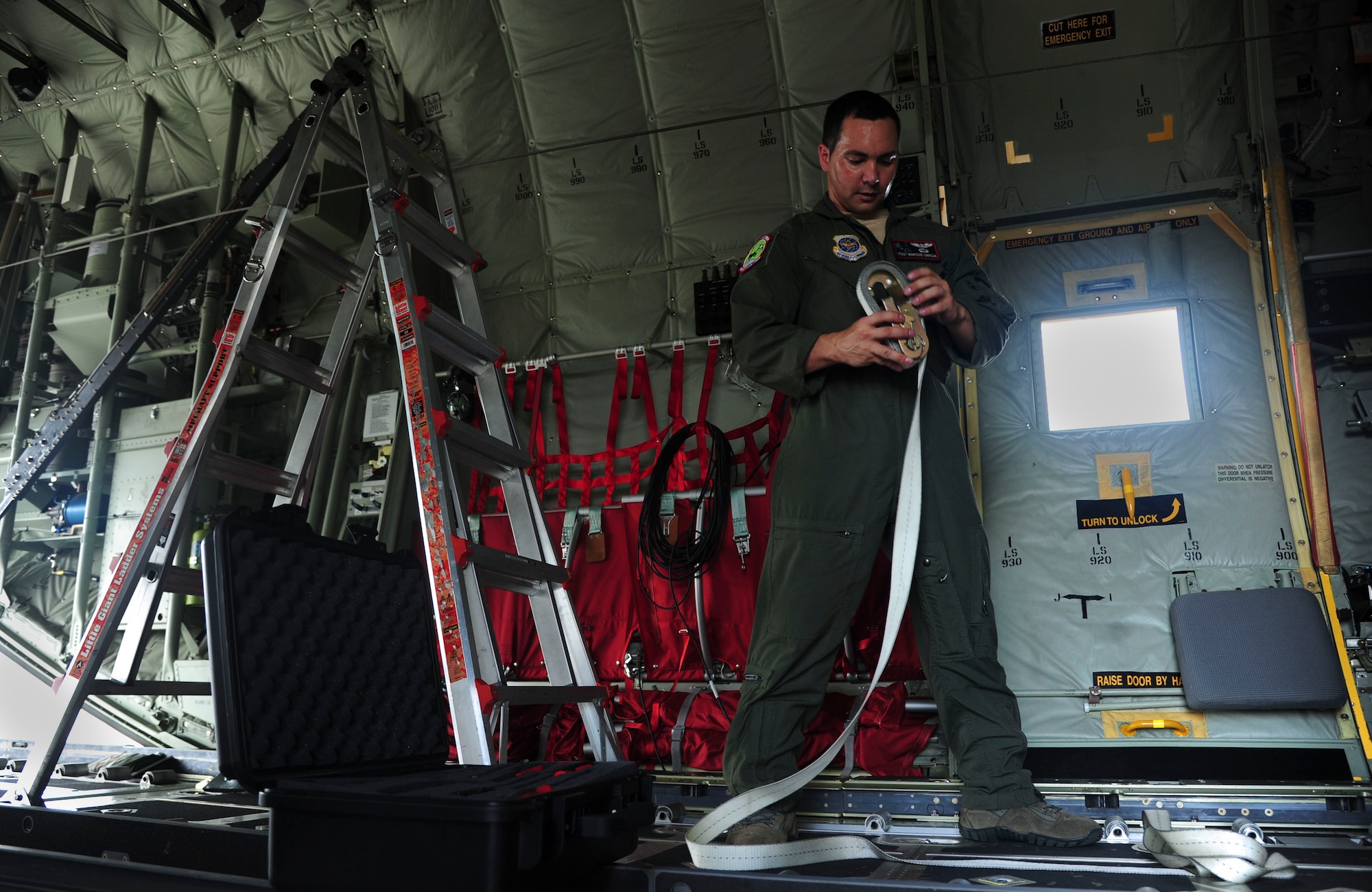 Tech. Sgt. Marcos Garcia, a 41st Airlift Squadron loadmaster, June 16, 2014, at Fort Polk, La. Cargo straps are rated to hold approximately 5,000 pounds. (U.S. Air Force photo by Senior Airman Kaylee Clark)