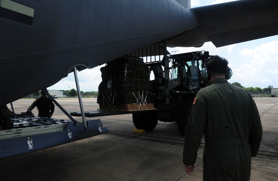 Tech. Sgt. Christopher Tyree, a 34th Combat Training Squadron loadmaster, directs a forklift June 16, 2014, at Fort Polk, Louisiana. The mission was to deliver supplies to troops on the ground and to do it safely and accurately. (U.S. Air Force photo/Senior Airman Kaylee Clark) 

