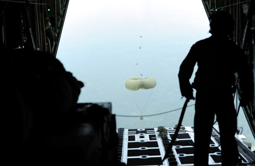 Senior Airman Jacob Vanderhalf, a 61st Airlift Squadron loadmaster, watches as Container Delivery System bundles exit the aircraft June 16, 2014, at Fort Polk, Louisiana. Little Rock Air Force Base daily operations are beginning to shift from Afghanistan to support of global contingency operations, humanitarian support and training exercises like Green Flag Little Rock. (U.S. Air Force photo/Senior Airman Kaylee Clark)