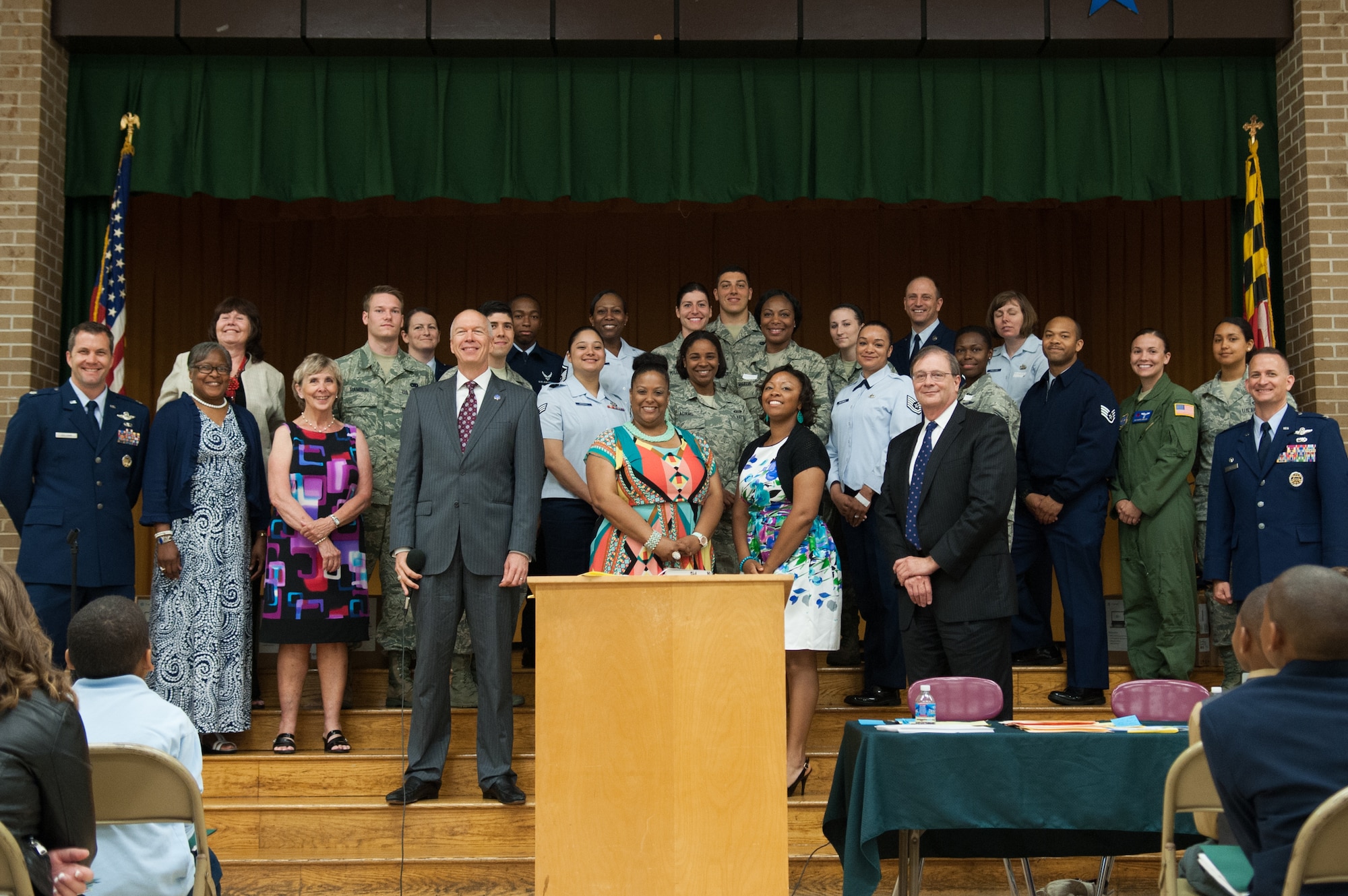 Representatives from Joint Base Andrews, Francis T. Evans Elementary School, and Area Coalitions Education-Excellence pose for a group photo at the school’s fifth-grade graduation ceremony, Clinton, Md., June 12. The students completed an eight-month mentorship program with Joint Base Andrews Airmen coordinated through the ACE-E program that connects public schools with government, military, private sector and local community volunteers. (U.S. Air Force photo/Aimee Fujikawa)



