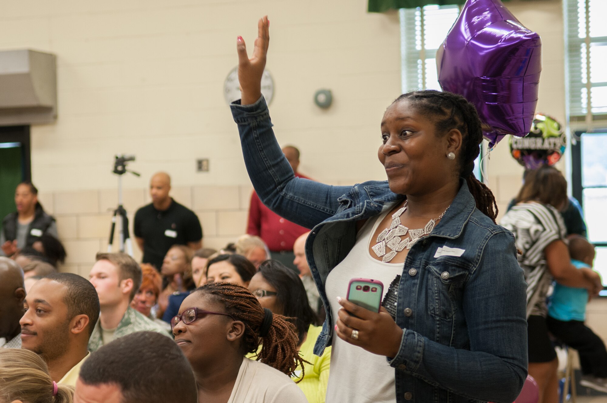 Tamika Gaskins, cheers for daughter Anaya Jackson as she received an award at the Francis T. Evans Elementary School fifth-grade graduation ceremony, Clinton, Md., June 12. The students completed an eight-month mentorship program with Joint Base Andrews Airmen coordinated through the Area Coalitions Education-Excellence program that connects public schools with government, military, private sector and local community volunteers. (U.S. Air Force photo/Aimee Fujikawa)

