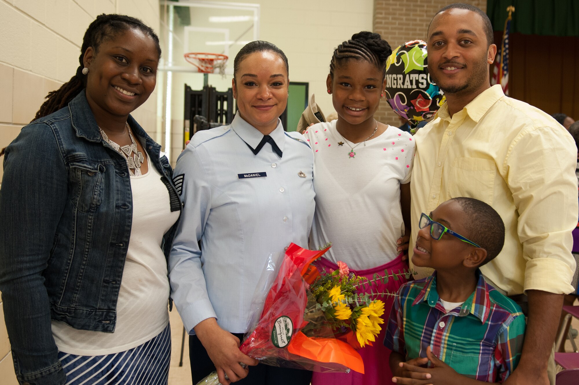 From left to right: Tamika Gaskins, Tech. Sgt. Sheliah McDaniel, Anaya Jackson, 11, Ernest Gaskins and Israel Gaskins, 7, pose for a photo at the Francis T. Evans Elementary School fifth-grade class graduation, Clinton, Md., June 12. The two fifth- grade classes also completed an eight-month mentorship program in which Joint Base Andrews Airmen served as mentors to the students through the Area Coalitions for Education-Excellence program that connects government, military, private sector and community volunteers with public schools. (U.S. Air Force photo/Aimee Fujikawa)