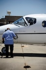 Herman Hidalgo, 47th Maintenance Directorate aircraft servicer, disconnects his head set from the T-1A Jayhawk at the flight line on Laughlin Air Force Base, Texas, June 10, 2014. The Directorate maintains the second largest active air fleet in the Air Force with 48 T-1A Jayhawks, 104 T-6A Texan IIs, and 65 T-38C Talons, 20 of which support the Introduction to Fighter Fundamentals mission. (U.S. Air Force photo/Staff Sgt. Steven R. Doty)(Released)
