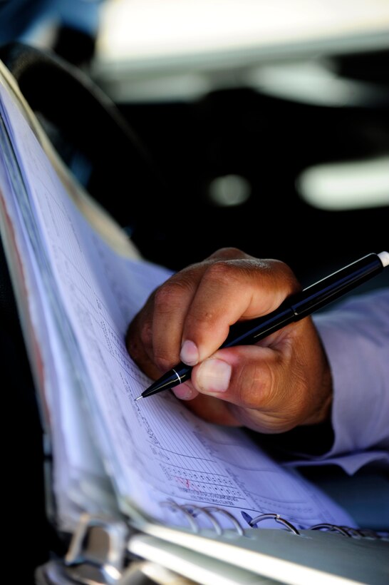 Lee Roy Garcia, 47th Maintenance Directorate aircraft servicer, signs a log at the flight line on Laughlin Air Force Base, Texas, June 10, 2014. The T-1A Jayhawk differs from its commercial counterpart with structural enhancements that provide for increased bird strike resistance and an additional fuselage fuel tank. (U.S. Air Force photo/Staff Sgt. Steven R. Doty)(Released)