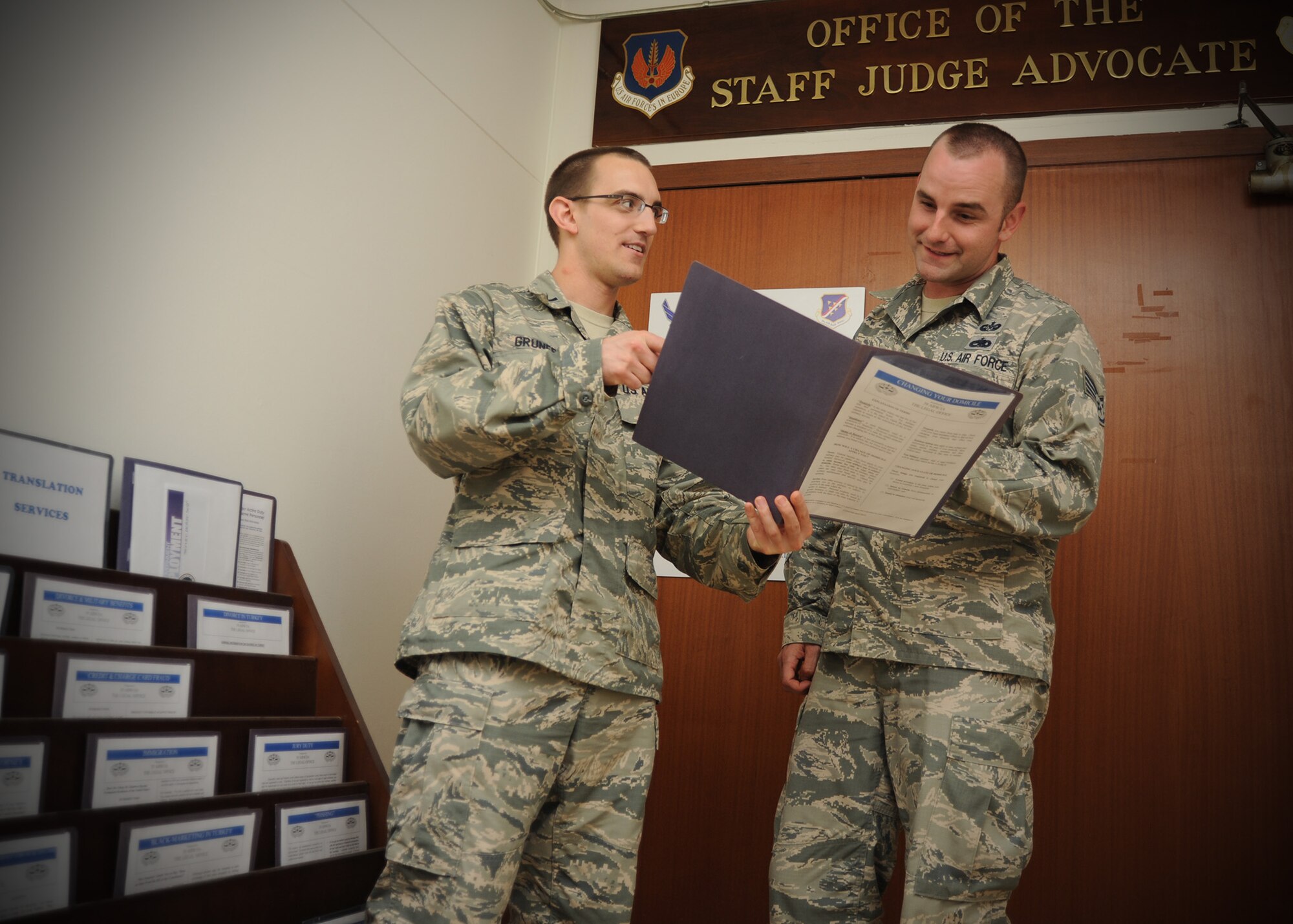 1st Lt. Jeremy Grunert, 39th Air Base Wing Legal Office chief of legal assistance, shows Staff Sgt. James Dorris, 39th ABW Legal Office NCO in charge of general law, legal references available to Airmen seeking legal guidance June 19, 2014, Incirlik Air Base, Turkey. Legal references can be found in front of the legal office located at the wing headquarters building. Judge advocates offer in-person legal assistance, and also offer a variety of resources to help the servicemen and women address their legal concerns. (U.S. Air Force photo by Staff Sgt. Veronica Pierce/Released) 