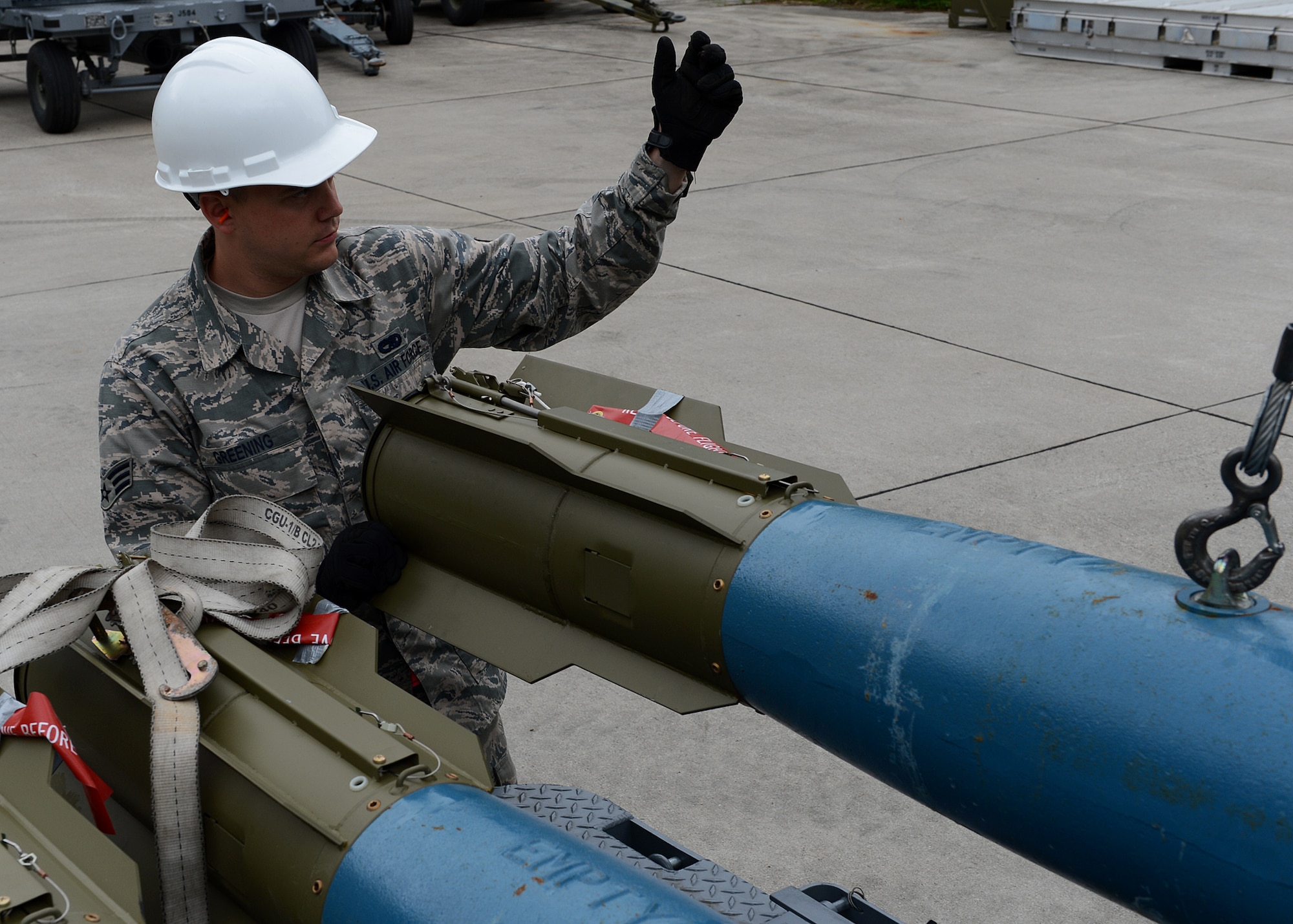 U.S. Air Force Senior Airman Timothy Greening, 52nd Equipment Maintenance Squadron precision guided munitions crew member from Norman, Okla., guides a Bomb Drop Unit-50 training explosive onto a transportation trailer at Lask Air Base, Poland, June 12, 2014. The 52nd EMS from Spangdahelm Air Base, Germany, supported the U.S. Aviation Detachment Rotation 14-3, U.S. Navy-led BALTOPS 14 and Polish led-EAGLE  TALON by loading 18 U.S. Air Force F-16 Fighting Falcon fighter aircraft with munitions. The Av-Det's mission is to increase interoperability and bilateral ties with Polish allies. (U.S. Air Force photo by Airman 1st Class Kyle Gese/Released)