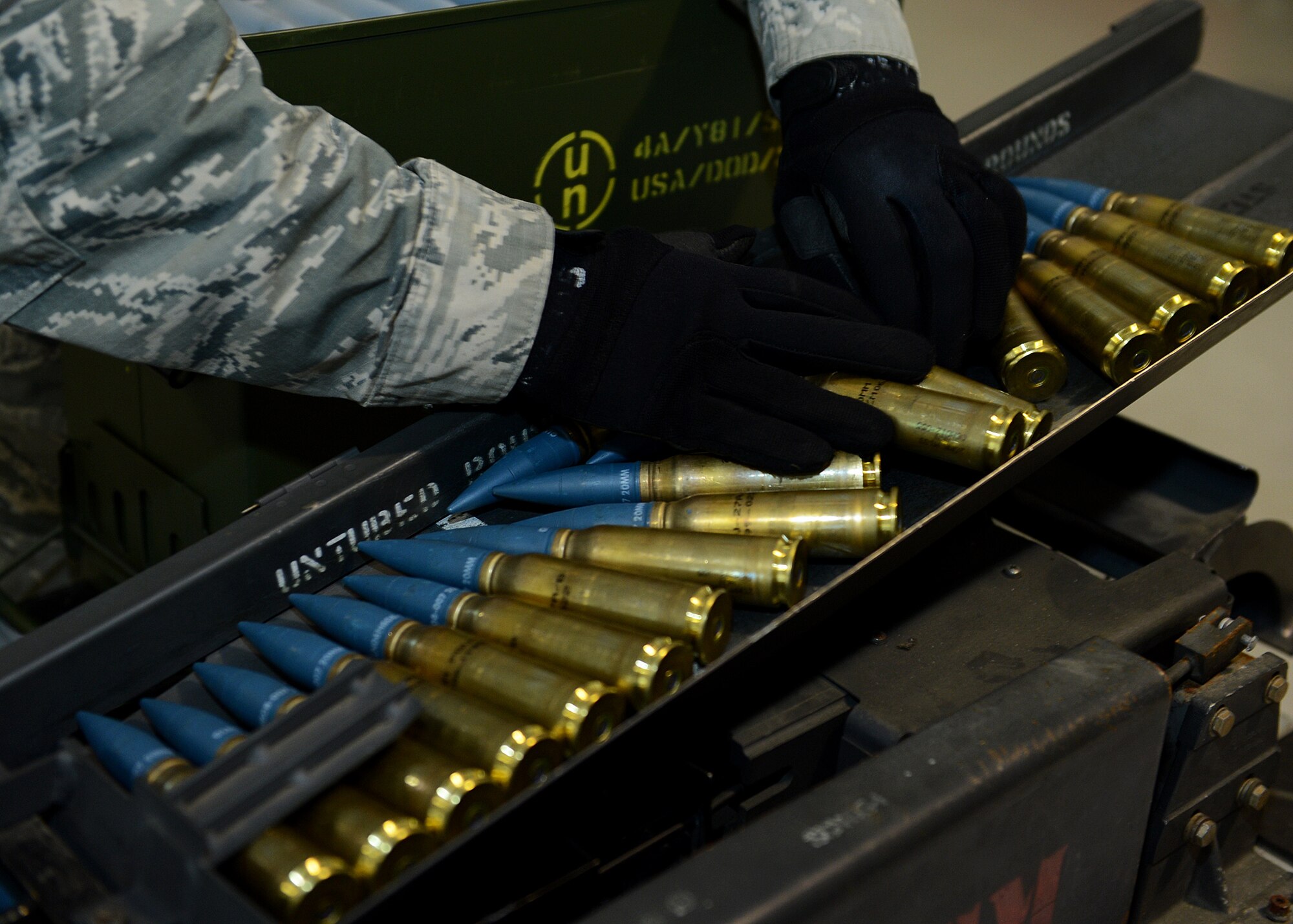 U.S. Air Force Staff Sgt. Jonathan Shelton, 52nd Equipment Maintenance Squadron munitions storage crew chief from Bassett, Va., places 20 mm target practice rounds on a replenisher table at Lask Air Base, Poland, June 12, 2014. An F-16 Fighting Falcon fighter aircraft carries approximately 512 rounds, which were used in multinational exercises BALTOPS 14 and EAGLE TALON to train NATO pilots for future close-air-support missions. Exercises such as these aim to increase interoperability and partnership capacity with NATO nations. (U.S. Air Force photo by Airman 1st Class Kyle Gese/Released)