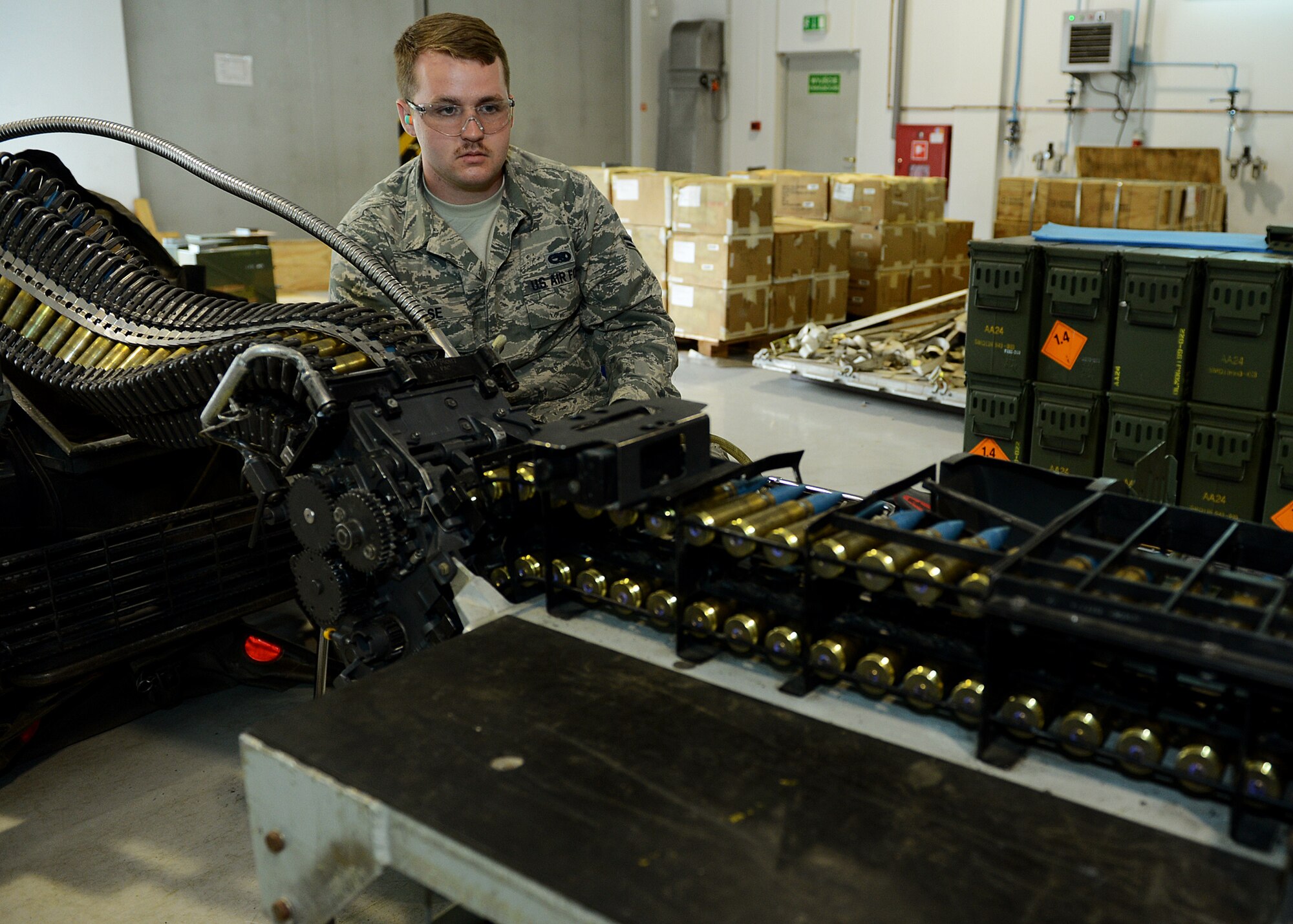 U.S. Air Force Airman 1st Class Joshua Hoose, 52nd Equipment Maintenance Squadron conventional maintenance crew member from Knoxville, Tenn., uses a replenisher table to load ammunition at Lask Air Base, Poland, June 12, 2014. Hoose loaded 20 mm target practice rounds to a universal ammunition loading system to support operations at the U.S. Aviation Detachment in Poland. The ammunition was used in exercises EAGLE TALON and BALTOPS 14, multinational theater security cooperation events in Eastern Europe. (U.S. Air Force photo by Airman 1st Class Kyle Gese/Released)