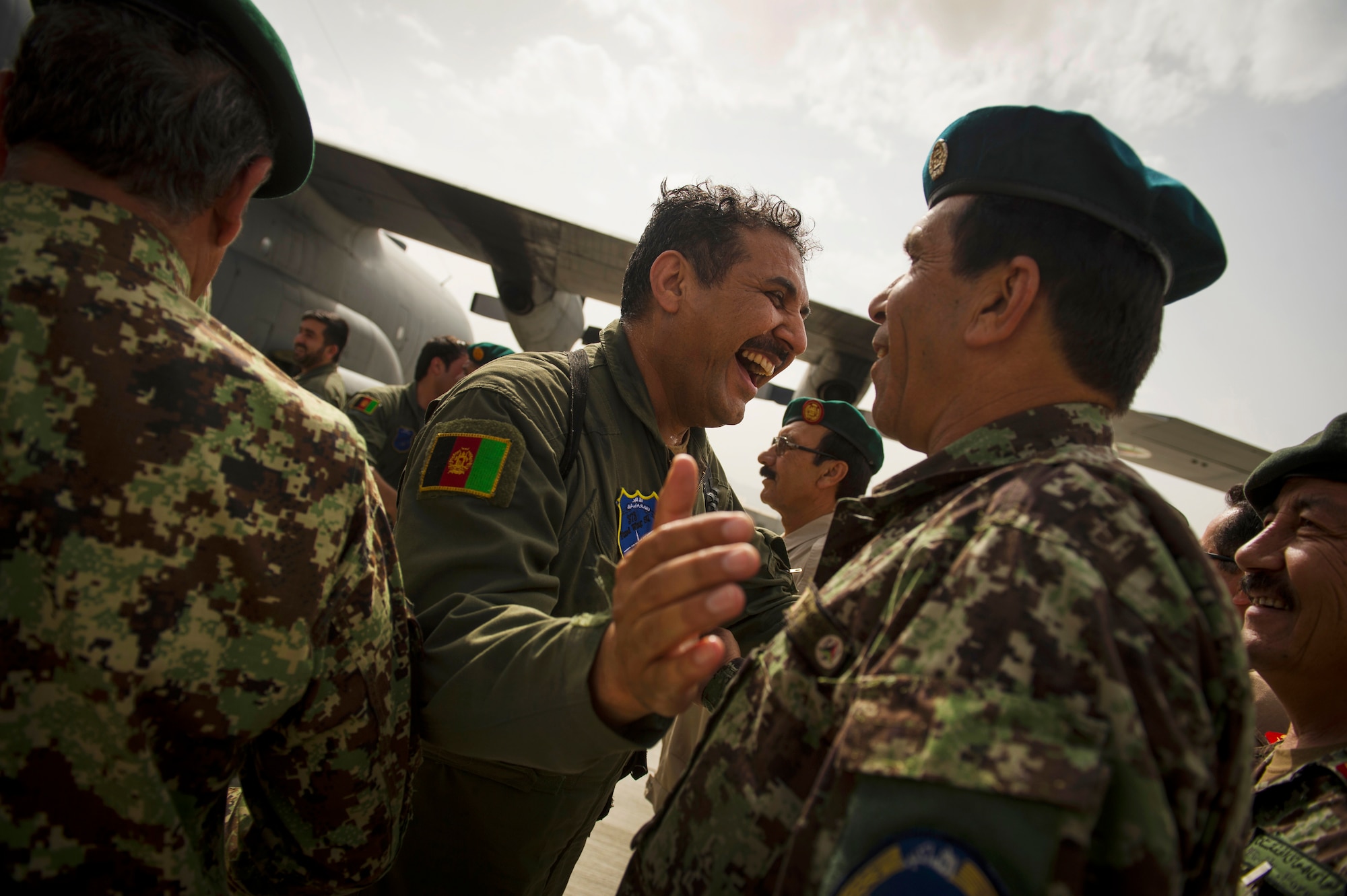 Afghan Air Force Col. Aimal Pacha, C-130 Hercules aircraft commander, gives celebratory hugs after flying the first-ever all Afghan C-130 flight, Kabul, Afghanistan, June 16, 2014. The aircrew, made up of six Afghan Air Force pilots and loadmasters, successfully completed a mission from Kabul to Kandahar and back. The aircrew successfully planned, executed and accounted for movement of about 120 Afghan personnel, two casualty evacuation patients, luggage and cargo in both directions. The ability for the AAF aircrew to move Afghan National Army Security Forces personnel, cargo, CASEVAC patients and human remains missions is a major accomplishment for both the AAF and NATO Air Training Command – Afghanistan advisors assigned to the 438th Air Expeditionary Wing. This milestone was accomplished eight months earlier than projected. (U.S. Air Force photo by Staff Sgt. Vernon Young Jr.)