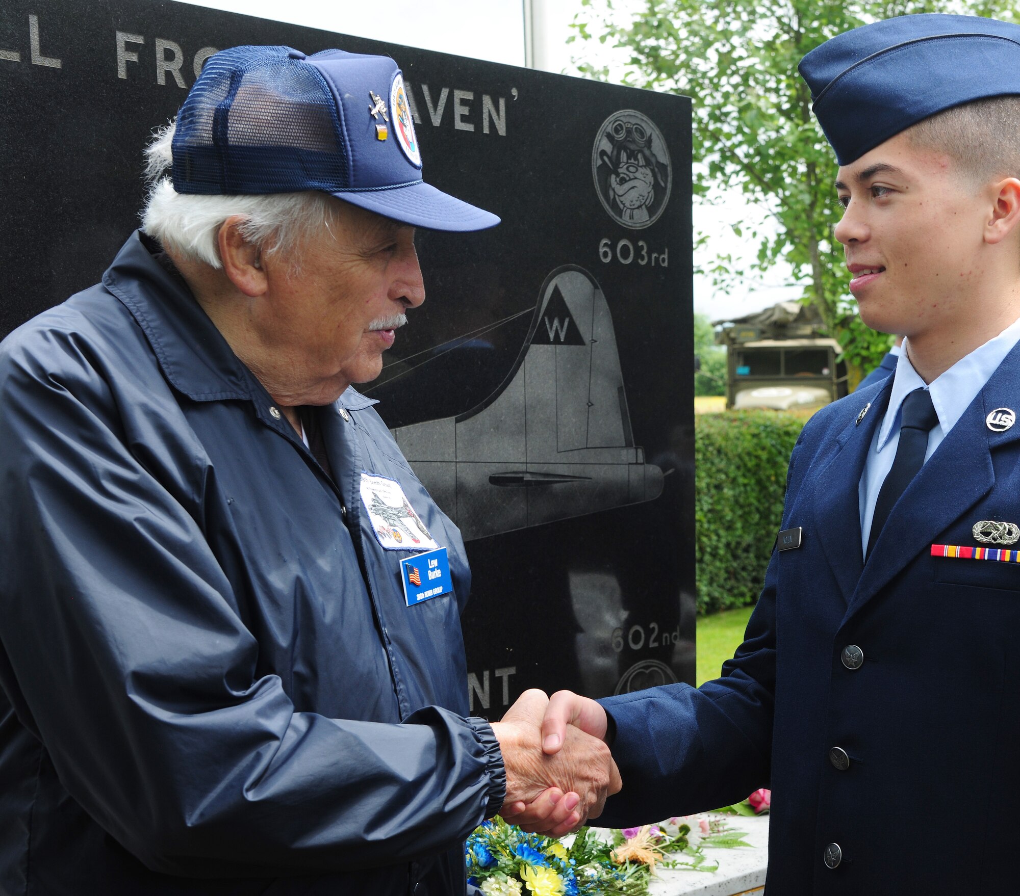 Lew Burke, left, a World War II veteran who was assigned to the 603rd Squadron, 398th Bombardment Group (Heavy), greets U.S. Air Force Airman 1st Class Charles Nolen, 48th Equipment Maintenance Squadron maintenance apprentice from Camarillo, Calif., after a Service of Commemoration June 14, 2014, at the Woodman Inn, Nuthampstead, England. Burke, a B-17 Flying Fortress co-pilot, flew 29 missions from Nuthampstead during the war. (U.S. Air Force photo/Staff Sgt. Rachel Waller/Released)