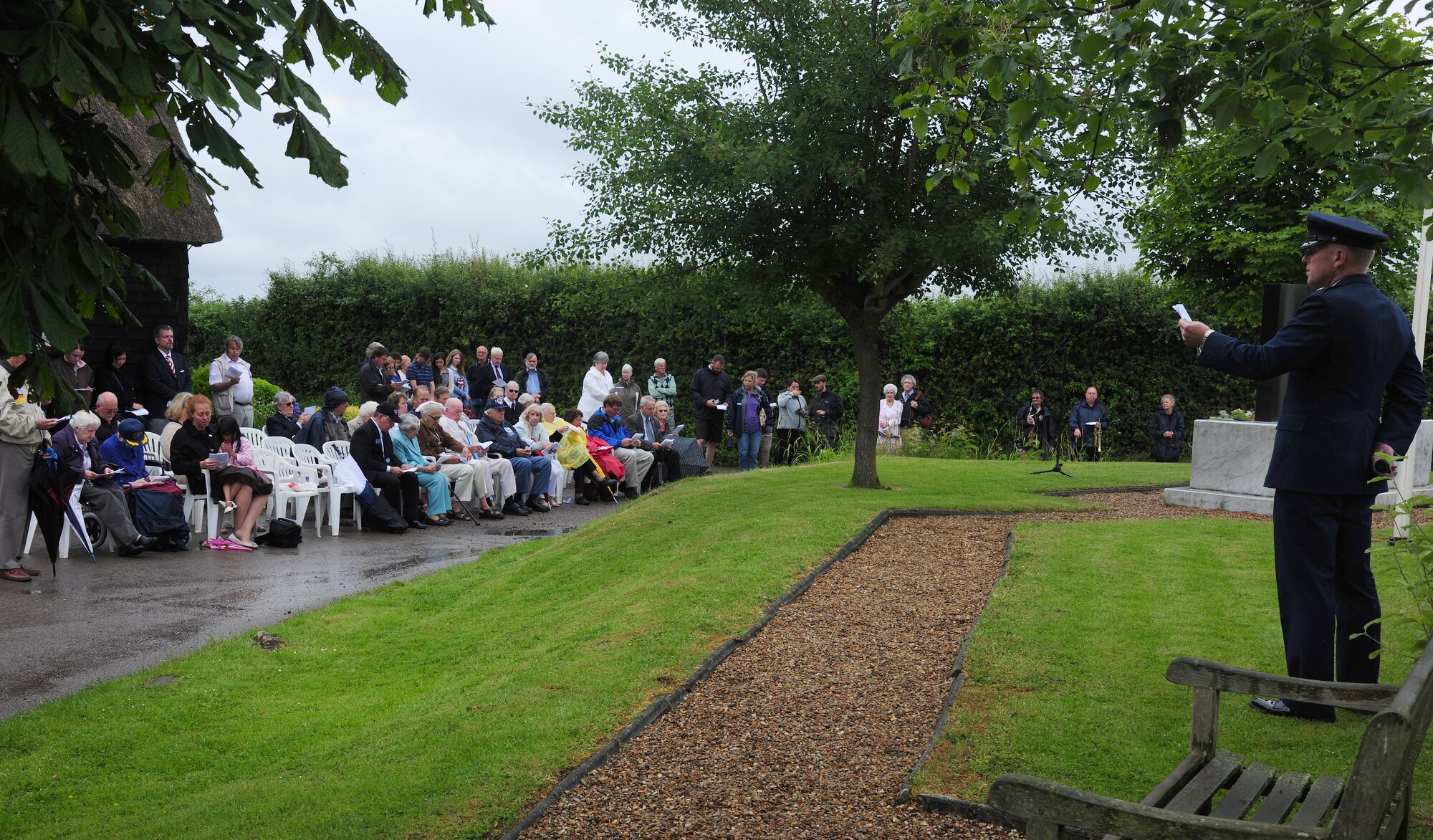 U.S. Air Force Chaplain (Lt. Col.) Gerald Snyder, right, 48th Fighter Wing Chaplain, leads attendees in a hymn during a Service of Commemoration June 14, 2014, at the Woodman Inn, Nuthampstead, England. The service was held in honor of the men from the 398th Bombardment Group (Heavy) and the 55th Fighter Group who lost their lives during World War II. (U.S. Air Force photo/Staff Sgt. Rachel Waller/Released)