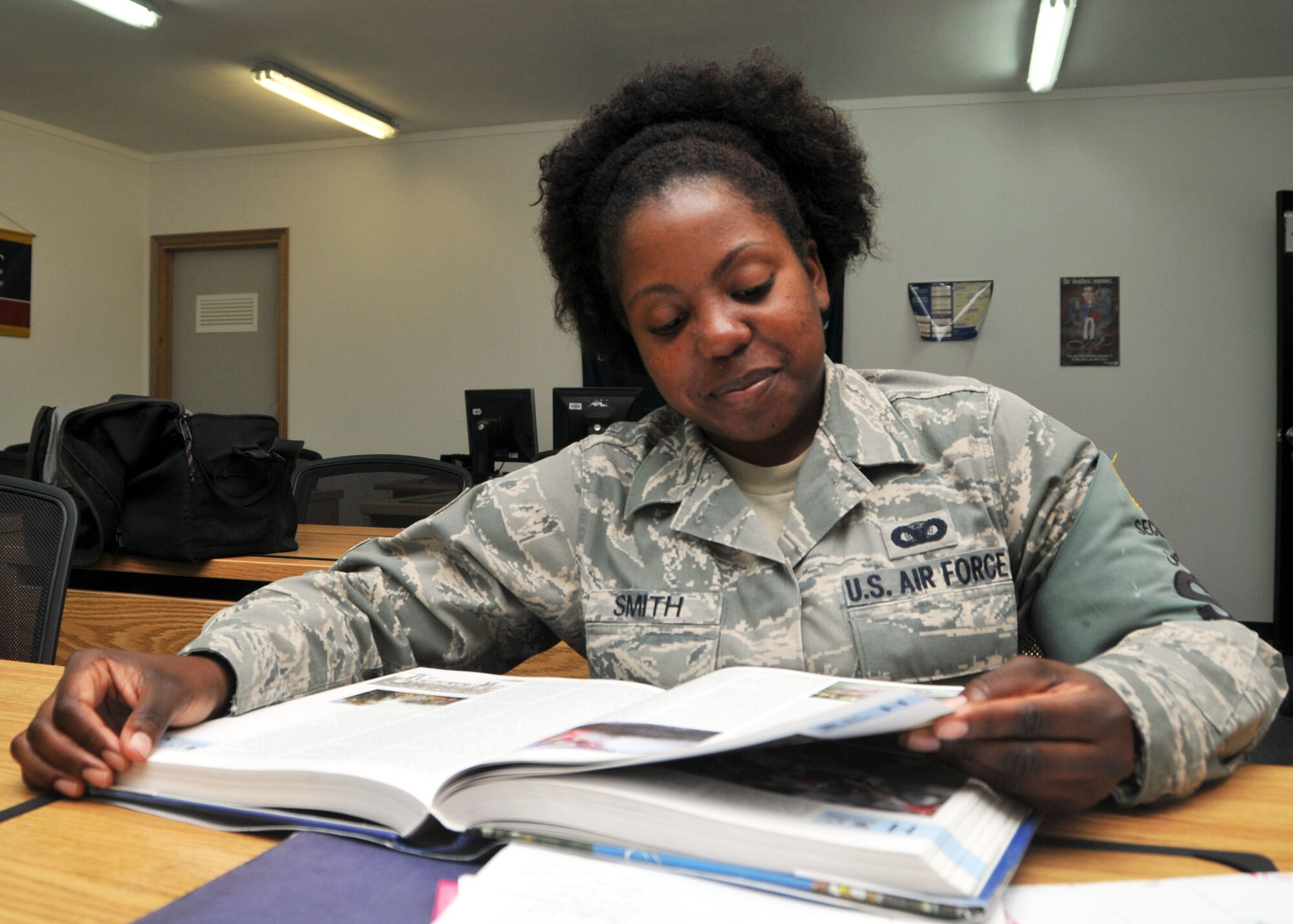 Air Force Staff Sgt. Chandra Smith reviews a book at the 380th Air Expeditionary Wing’s learning resource center at an undisclosed location in Southwest Asia June 4, 2014. (U.S. Air Force photo by Senior Master Sgt. Eric Peterson/Released)