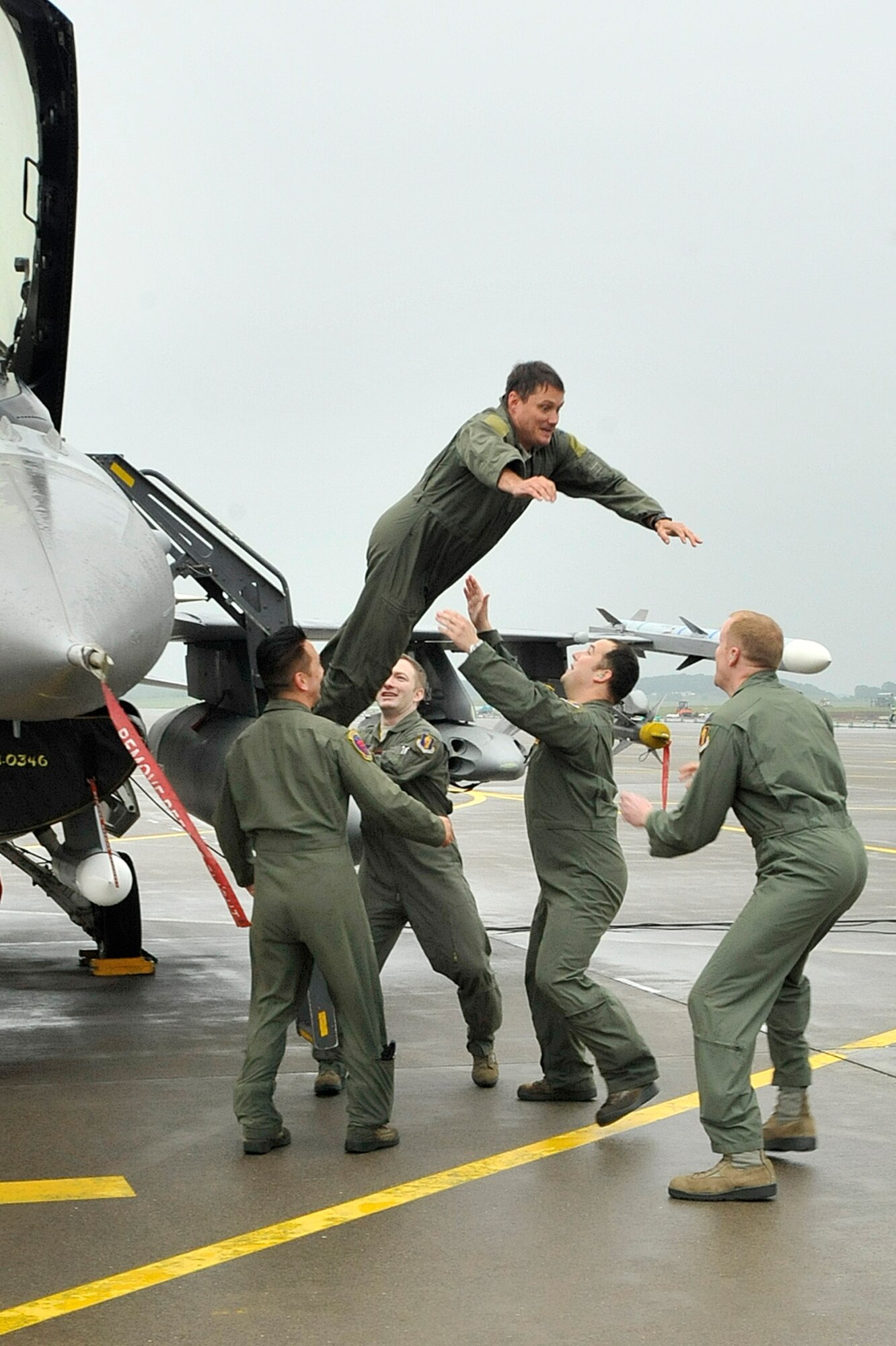 U.S. Air Force Col. Matthew Dana, 35th Fighter Wing vice commander, leaps from his F-16 Fighting Falcon after his fini-flight at Misawa Air Base, Japan, June 16, 2014. This marked Dana’s last flight here as he will soon assume command at the Utah Test and Training Range, part of the 388th Fighter Wing, at Hill Air Force Base, Utah. (U.S. Air Force photo/ Staff Sgt. Tong Duong)