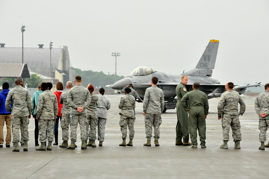 Misawa Air Base members await the arrival of Col. Matthew Dana, 35th Fighter Wing vice commander, during his fini-flight at Misawa Air Base, Japan, June 16, 2014. Dana was received by base and family members after his final flight at Misawa, which culminated his two years here. (U.S. Air Force photo/ Staff Sgt. Tong Duong)