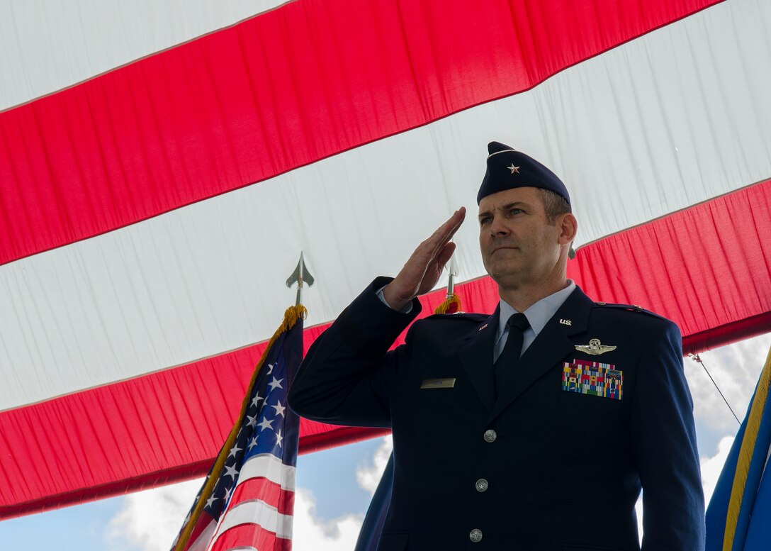 Brig. Gen. Andrew Toth, 36th Wing commander, performs his first salute to Team Andersen June 19, 2014, on Andersen Air Force Base, Guam. Toth assumed command of the wing from   Brig. Gen. Steven Garland during a change of command ceremony. (U.S. Air Force photo by Senior Airman Katrina M. Brisbin/Released)