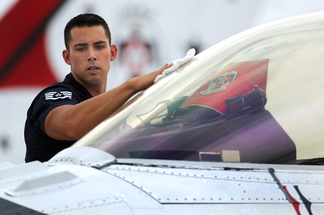 Air Force Staff Sgt. Christopher Audet wipes down the canopy on a Thunderbirds F-16 aircraft during post-flight inspections following the Rockford AirFest demonstration at Chicago Rockford International Airport, June 7, 2014. Audet, an aircraft maintenance specialist, is assigned to the Thunderbirds air demonstration squadron.