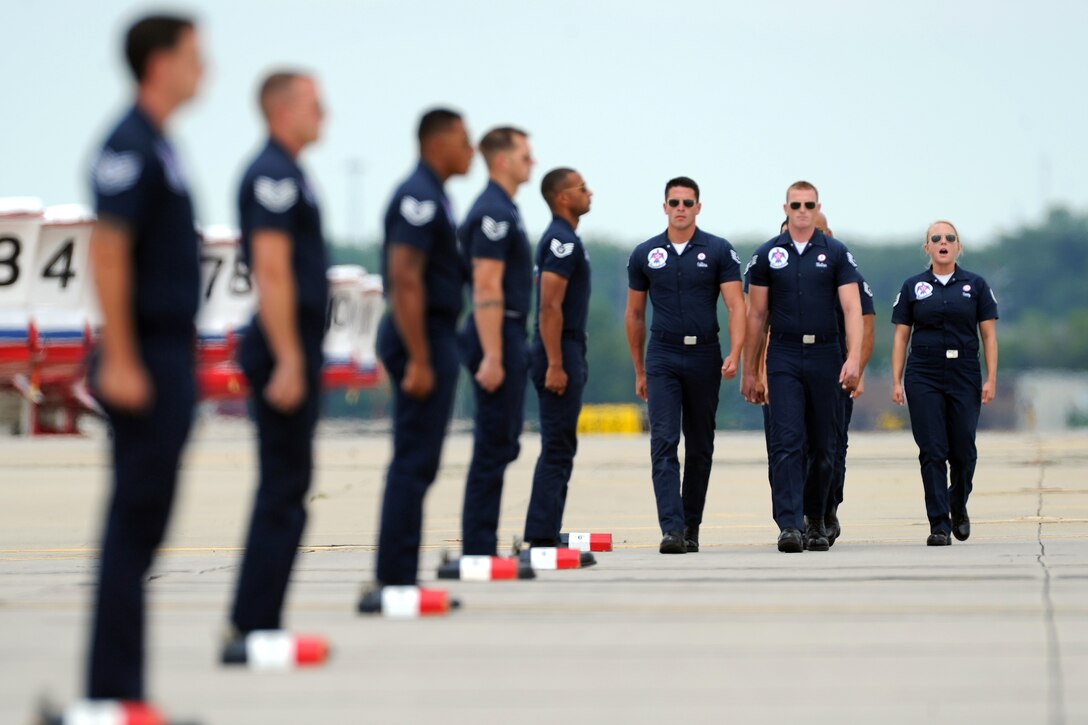 The U.S. Air Force Thunderbirds maintenance professionals march in formation during their ground show performance at Rockford AirFest at Chicago Rockford International Airport, June 8, 2014.