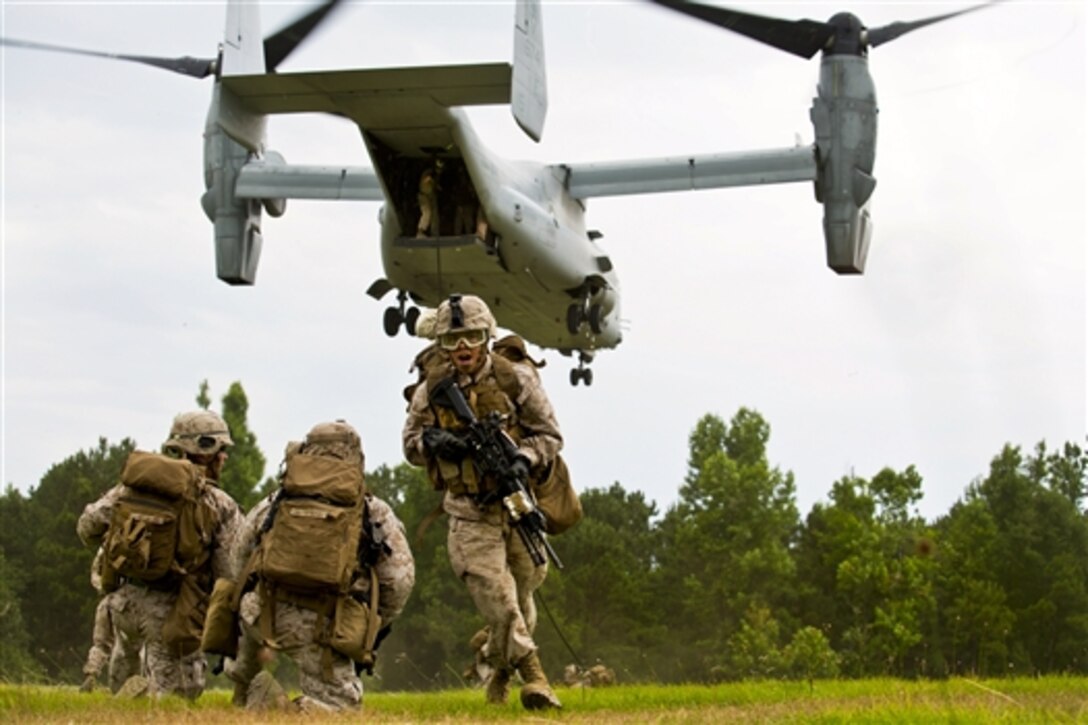 Some Marines provide security while others fast-rope from an MV-22 Osprey aircraft during training on Camp Lejeune, N.C., June 9, 2014. The training allowed Marines to apply proper fast-roping techniques and procedures. Bell is a squad leader assigned to Fox Company, 2nd Battalion, 2nd Marine Regiment. 