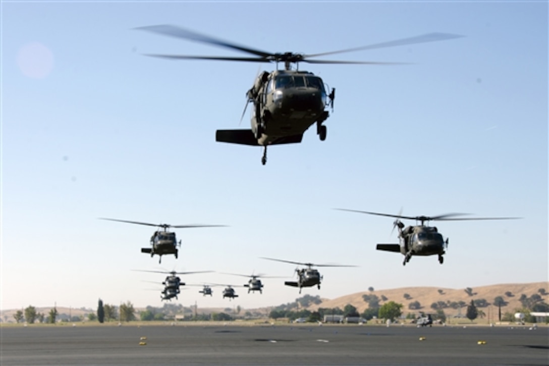 UH-60 Black Hawk helicopters lift off in a tactical formation from Camp Roberts, Calif., June 15, 2014, to pick up soldiers for an air assault mission. The helicopter crews are assigned to the 1st Battalion, 140th Aviation Regiment, 40th Combat Aviation Brigade. 