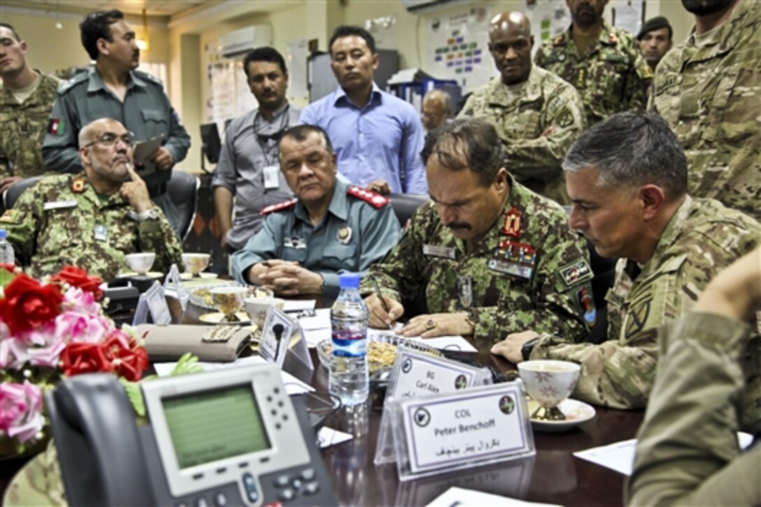 Afghan security forces await presidential runoff election results and plan counterinsurgency tactics as U.S. members of the International Security Assistance Force assist in the operations center on Forward Operating Base Gamberi in Afghanistan's Laghman province, June 14, 2014. Afghan forces were responsible for ensuring the safety of the Afghan people during the elections. 