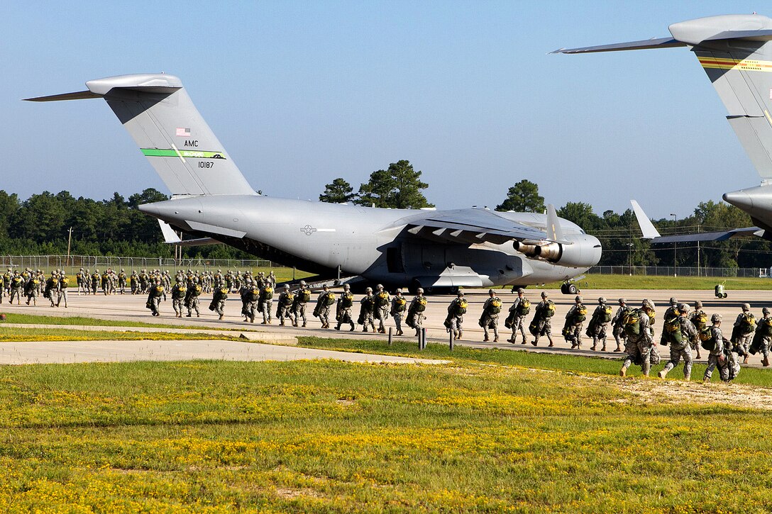Army paratroopers load into C-17 Globemaster III aircraft for a mass-tactical airborne training operation on Pope Field near Fort Bragg, N.C., Sept. 10, 2011. The paratroopers are assigned to the 82nd Airborne Division's 1st Brigade Combat Team.  
