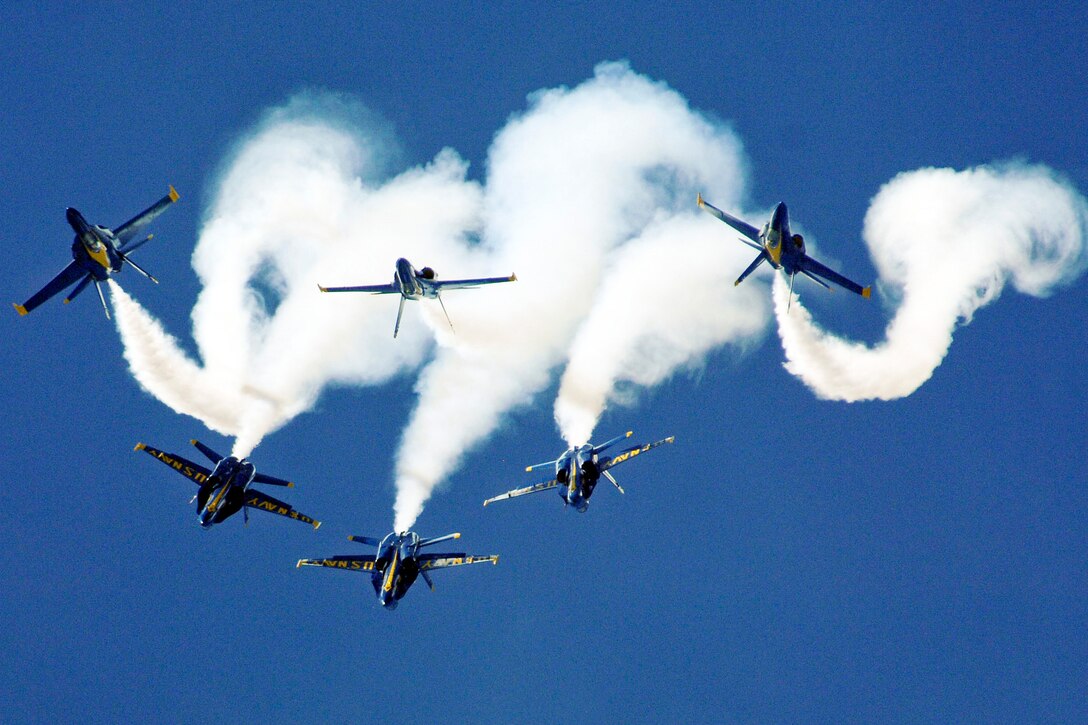 The Navy flight demonstration squadron, the Blue Angels, perform the Loop Break Cross maneuver at the Guardians of Freedom Air Show in Lincoln, Neb., Sept. 11, 2011. The Blue Angels performed as part of the 2011 show season and in celebration of the Centennial of Naval Aviation.  
