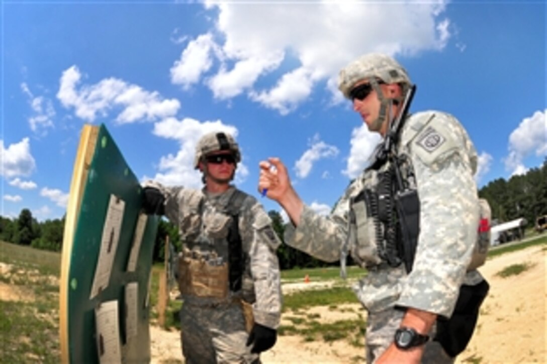 A paratrooper reviews his zeroing card before making any adjustments needed to zero his rifle during a live-fire exercise on Fort Pickett, Va., June 7, 2014. The paratrooper, a rifleman, is assigned to the 82nd Airborne Division's Company C, 2nd Battalion, 501st Parachute Infantry Regiment, 1st Brigade Combat Team.
