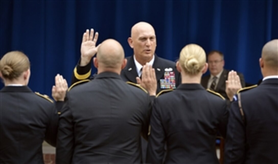 Army Chief of Staff. Gen. Raymond T. Odierno re-enlists a group of soldiers during a cake-cutting ceremony to commemorate the Army's 239th Birthday at the Pentagon, June 19, 2014. Deputy Defense Secretary Bob Work, background, and other senior leaders also participated.