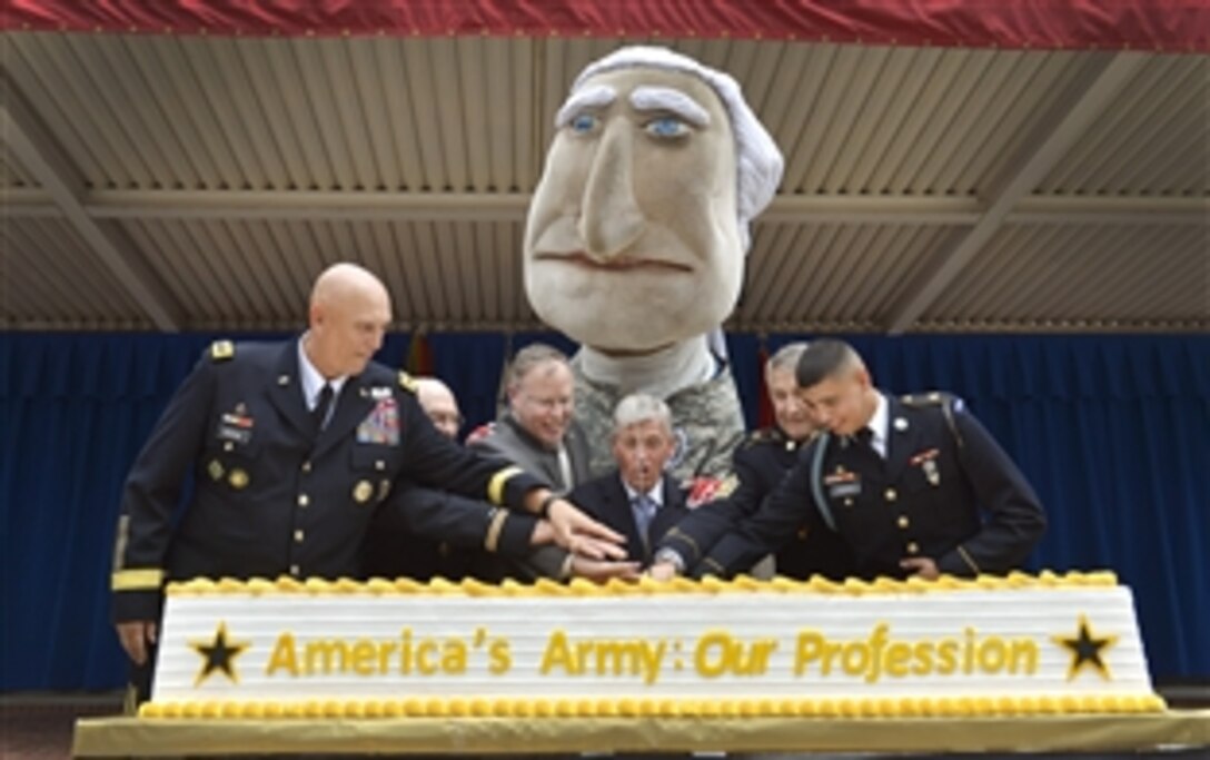 Deputy Defense Secretary Bob Work, third from left, joins Army Secretary John McHugh, center, and Army Chief of Staff Gen. Ray T. Odierno, left, to commemorate the Army's 239th birthday in a cake-cutting ceremony at the Pentagon, June 19, 2014. 