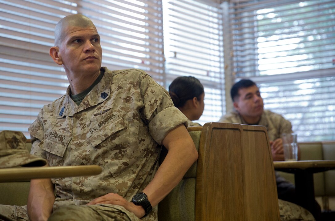 Sgt. Maj. Arthur M. Arebalo Jr. listens June 11 during an open discussion between the Marines and commanding officer of Marine Wing Headquarters Squadron 1 at the Camp Foster Mess Hall. The meeting is held monthly to afford junior Marines the opportunity to ask questions about leadership skills, policies and upcoming events. Arebalo is a Fontana, California, native and the sergeant major of MWHS-1, 1st Marine Aircraft Wing, III Marine Expeditionary Force. (U.S. Marine Corps photo by Lance Cpl. Diamond N. Peden/Released) 
