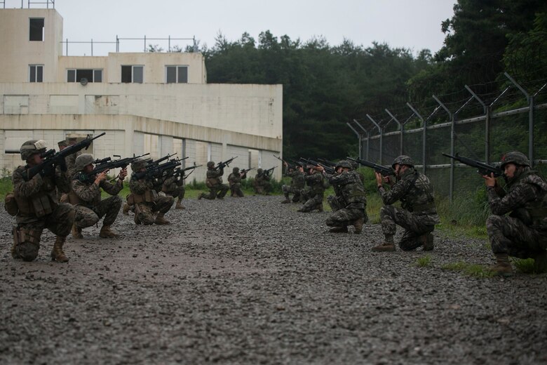 Republic of Korea and U.S. Marines post security June 11 during military operations on urbanized terrain training at the MOUT training center in Pohang, Republic of Korea. The two-day training evolution covered the basics of patrolling through an urban environment, reacting to enemy contact, crossing danger areas, as well as  clearing out rooms, stairwells and buildings. The U.S. Marines are in Pohang to take part in the Korean Marine Exchange Program 14-8, a combined, small-unit training exercise, which enhances the combat readiness and interoperability of ROK-U.S. Marine Corps forces. The ROK Marines are military policemen with Military Police Company, 2nd ROK Marine Division. The U.S. Marines are military policemen with Company C, 3rd Law Enforcement Battalion, III Marine Expeditionary Force Headquarters Group, III MEF. (U.S. Marine Corps photo by Lance Cpl. Drew Tech/Released)