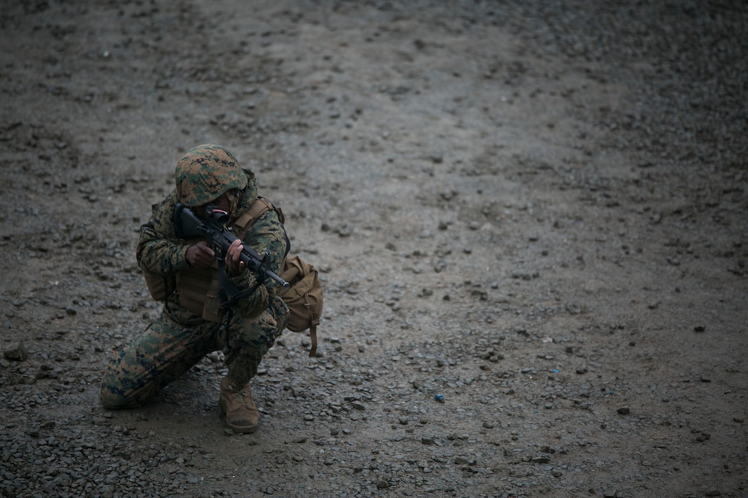 U.S. Marine Lance Cpl. Stephen H. Rawls posts security on a patrol June 11 during military operations on urbanized terrain training at the MOUT training center in Pohang, Republic of Korea. The two-day training evolution covered the basics of patrolling through an urban environment, reacting to enemy contact, crossing danger areas, as well as  clearing out rooms, stairwells and buildings. The U.S. Marines are in Pohang to take part in the Korean Marine Exchange Program 14-8, a combined, small-unit training exercise, which enhances the combat readiness and interoperability of ROK-U.S. Marine Corps forces. Rawls is a military policeman with Company C, 3rd Law Enforcement Battalion, III Marine Expeditionary Force Headquarters Group, III MEF. (U.S. Marine Corps photo by Lance Cpl. Drew Tech/Released)