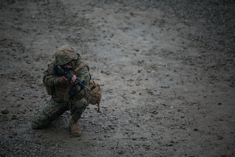 U.S. Marine Lance Cpl. Stephen H. Rawls posts security on a patrol June 11 during military operations on urbanized terrain training at the MOUT training center in Pohang, Republic of Korea. The two-day training evolution covered the basics of patrolling through an urban environment, reacting to enemy contact, crossing danger areas, as well as  clearing out rooms, stairwells and buildings. The U.S. Marines are in Pohang to take part in the Korean Marine Exchange Program 14-8, a combined, small-unit training exercise, which enhances the combat readiness and interoperability of ROK-U.S. Marine Corps forces. Rawls is a military policeman with Company C, 3rd Law Enforcement Battalion, III Marine Expeditionary Force Headquarters Group, III MEF. (U.S. Marine Corps photo by Lance Cpl. Drew Tech/Released)
