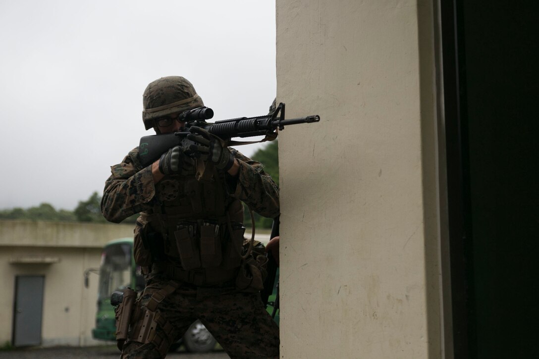 U.S. Marine Lance Cpl. Matthew N. Wachter pivots around a corner June 11 during military operations on urbanized terrain training at the MOUT training center in Pohang, Republic of Korea. The two-day training evolution covered the basics of patrolling through an urban environment, reacting to enemy contact, crossing danger areas, as well as  clearing out rooms, stairwells and buildings. The U.S. Marines are in Pohang to take part in the Korean Marine Exchange Program 14-8, a combined, small-unit training exercise, which enhances the combat readiness and interoperability of ROK-U.S. Marine Corps forces. Wachter is a military policeman with Company C, 3rd Law Enforcement Battalion, III Marine Expeditionary Force Headquarters Group, III MEF. (U.S. Marine Corps photo by Lance Cpl. Drew Tech/Released)